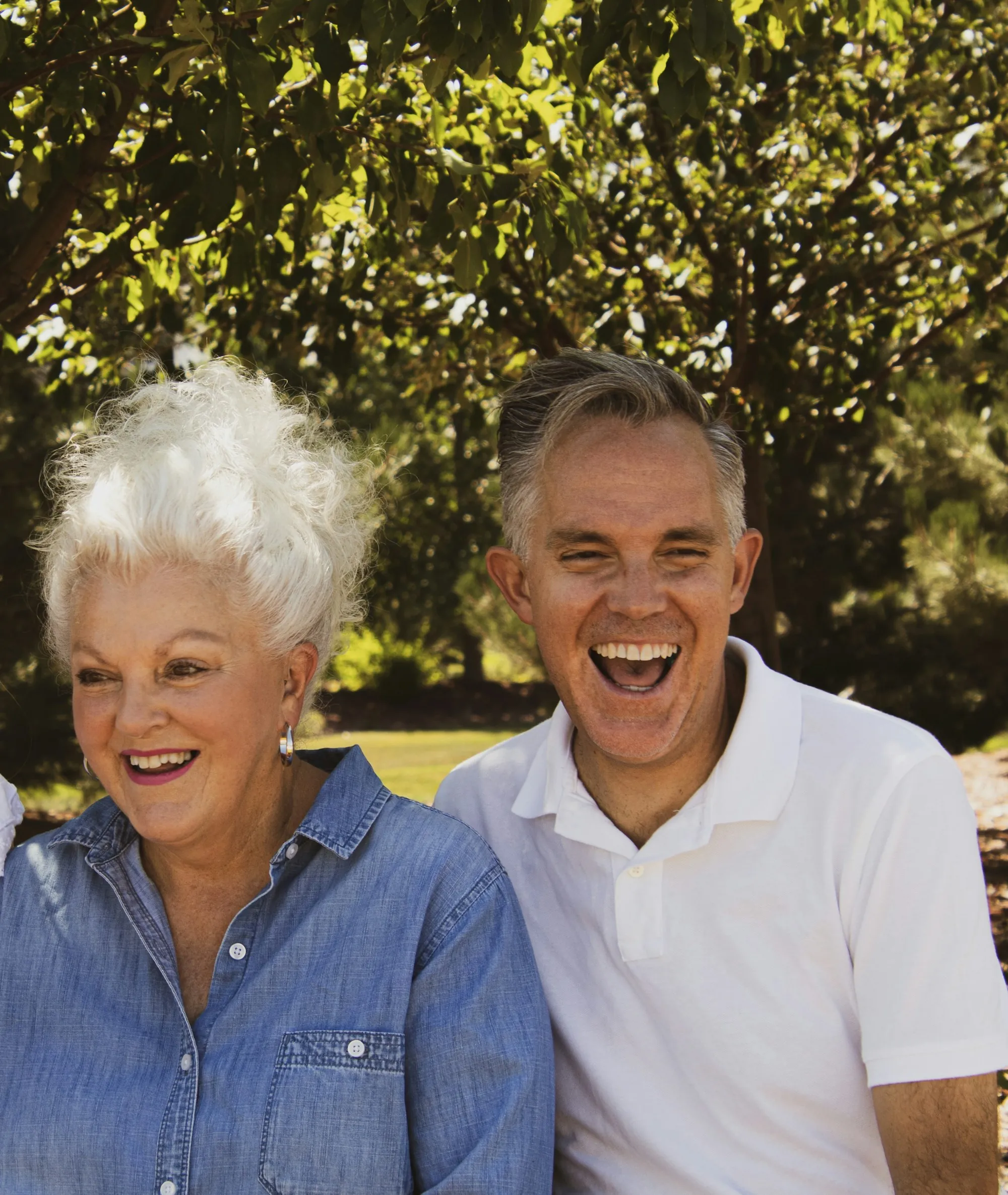 Senior couple laughing outdoors in the sun